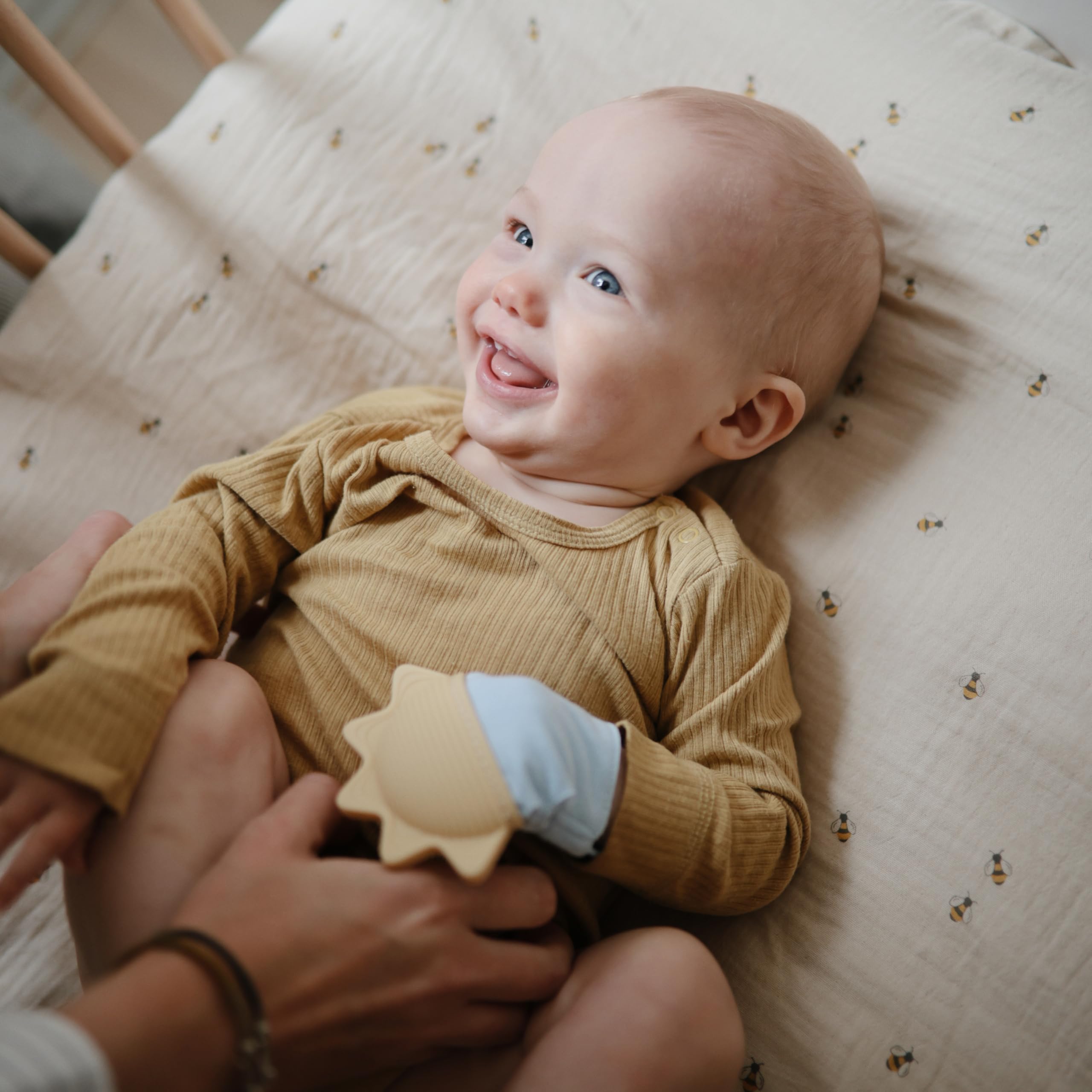 Mushie teething mitten soft cotton fabric protecting skin during saliva exposure