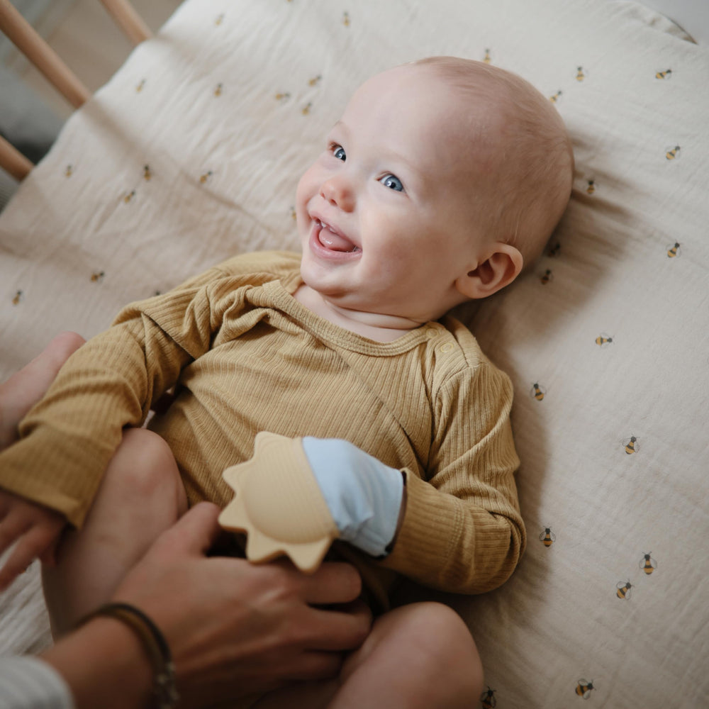 Mushie teething mitten soft cotton fabric protecting skin during saliva exposure