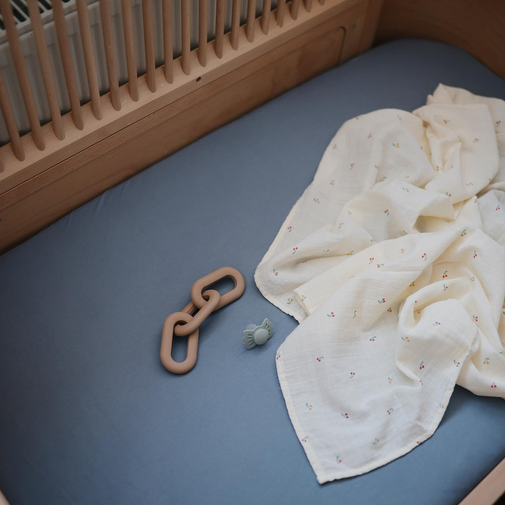 Mushie Tradewinds crib sheet breathable fabric supports baby warmth