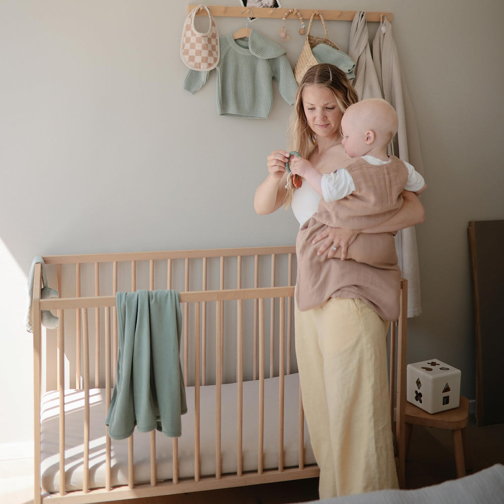 Mushie Tradewinds crib sheet organic cotton elastane blend offers gentle stretch