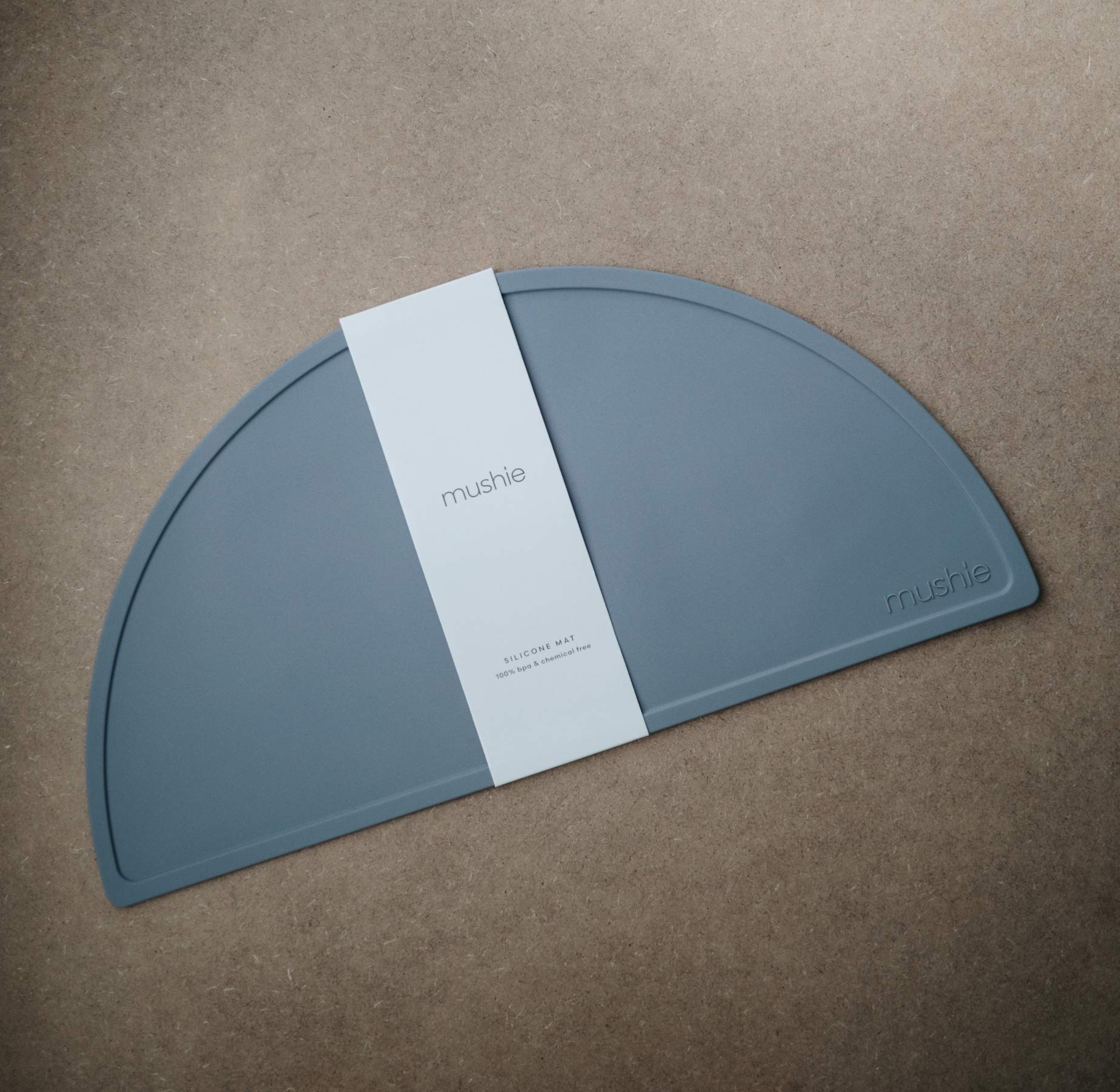 Mushie Tradewinds non-slip placemat close-up shows stable mealtime surface.