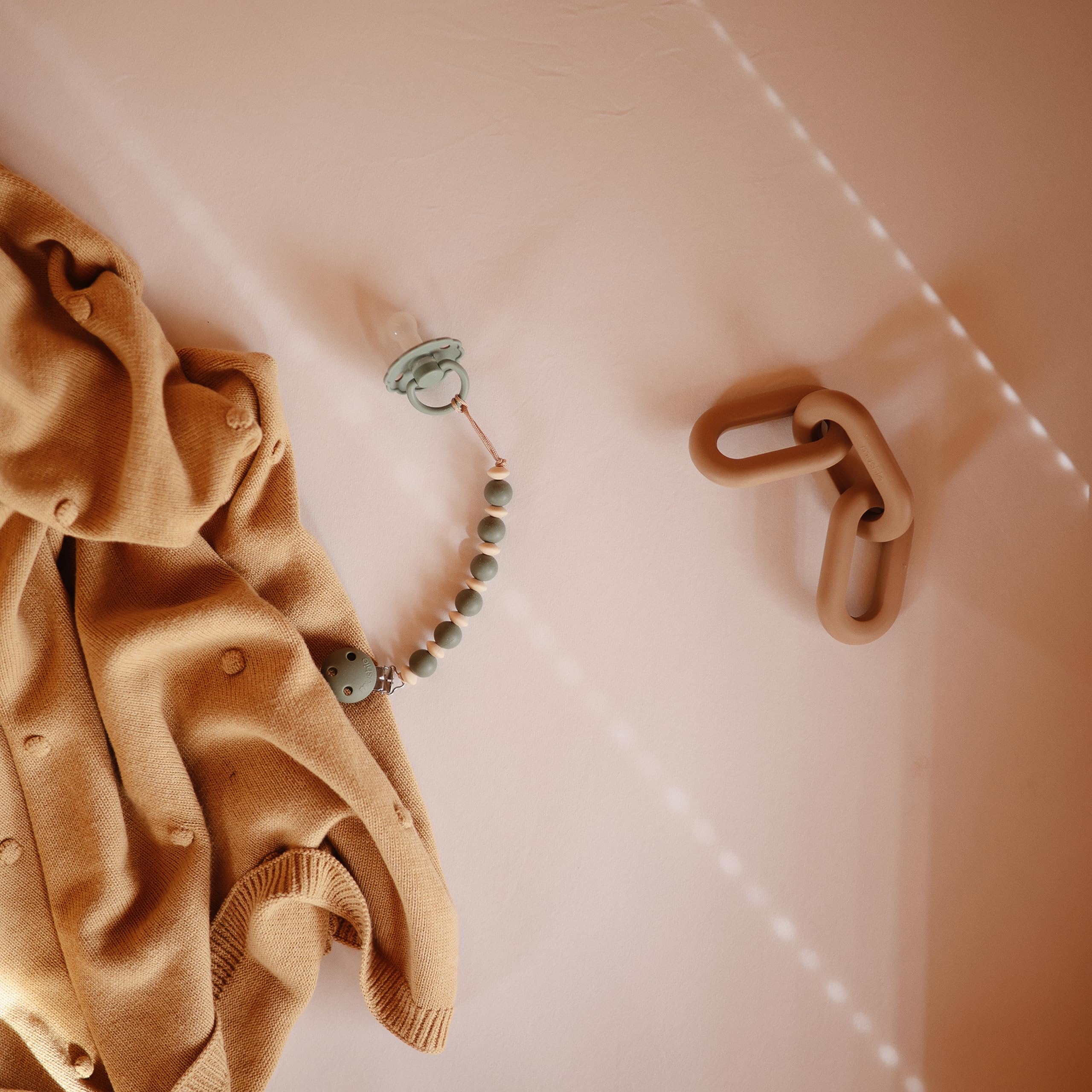 Mushie Tradewinds teether with modern design complements stylish nurseries.