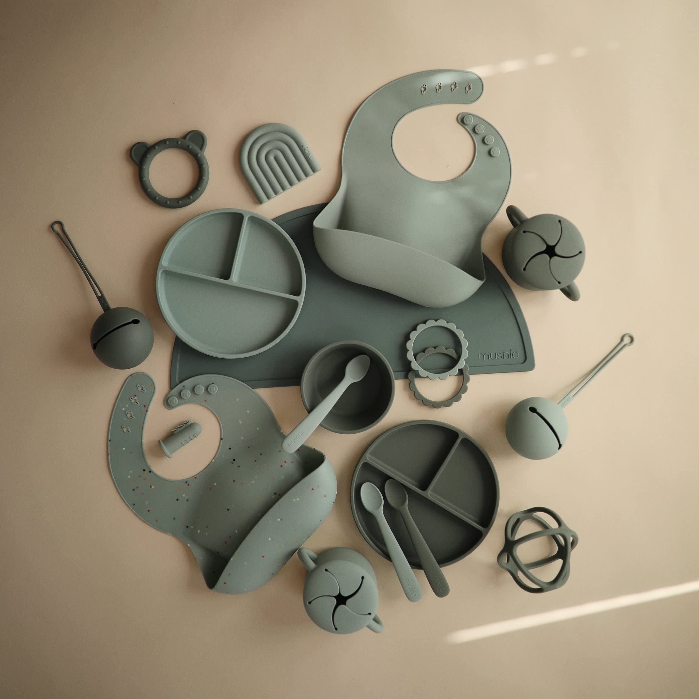 Mushie training cup straw in-use with gentle flow for toddlers.
