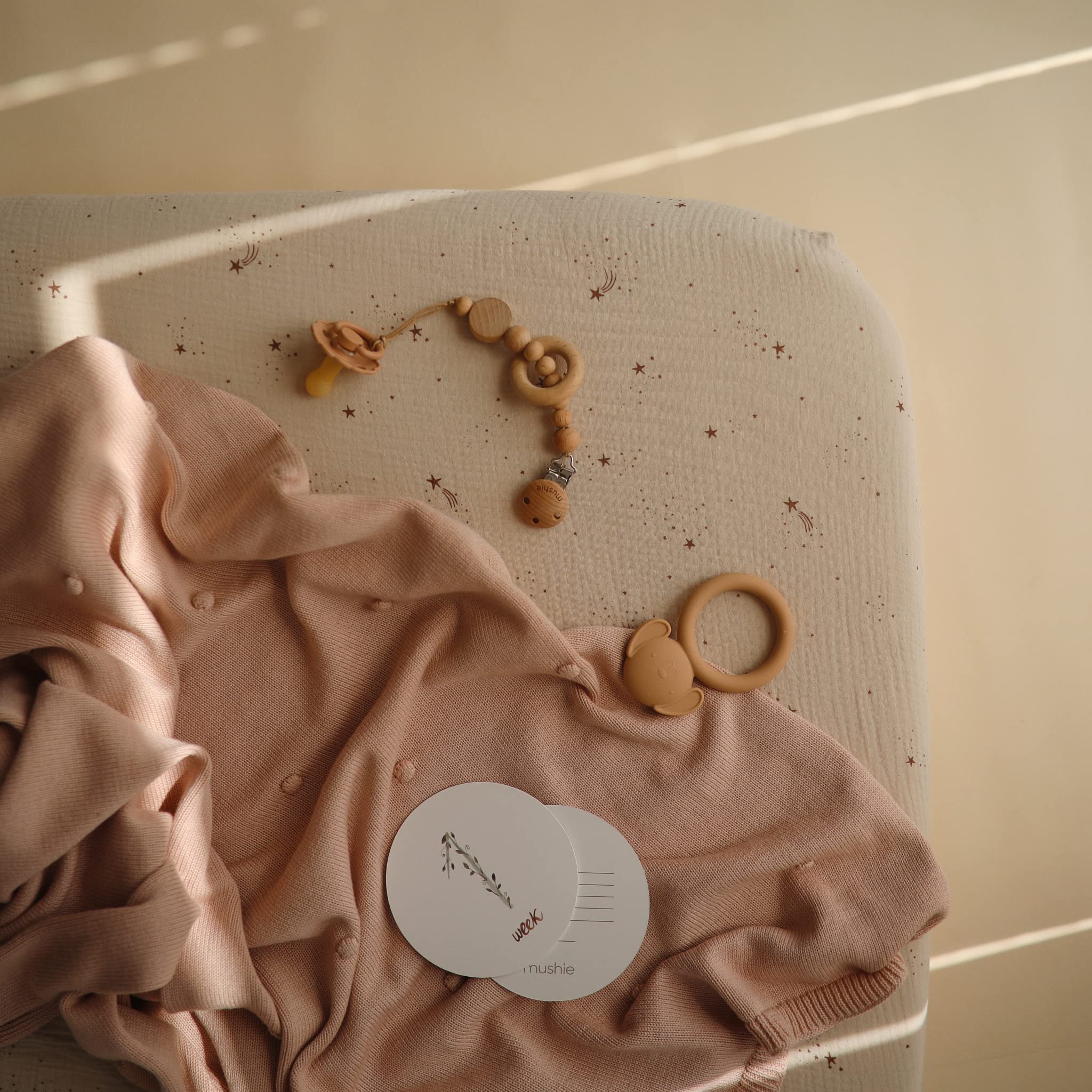 Mushie 52x28 standard crib mattress fit shown in closeup