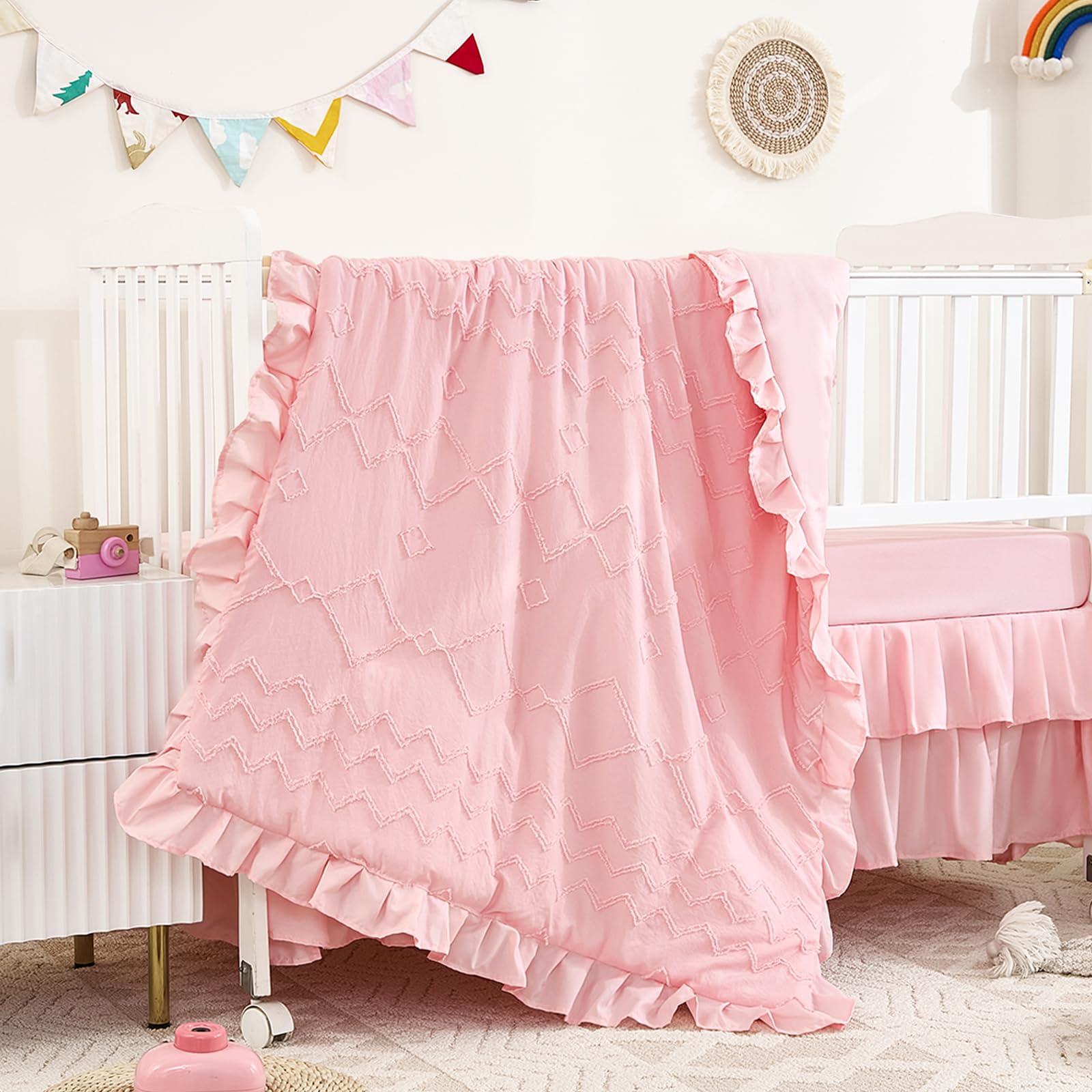 NacoMoco tufted-ruffle-crib-comforter-light-pink provides cozy warmth for baby nights.