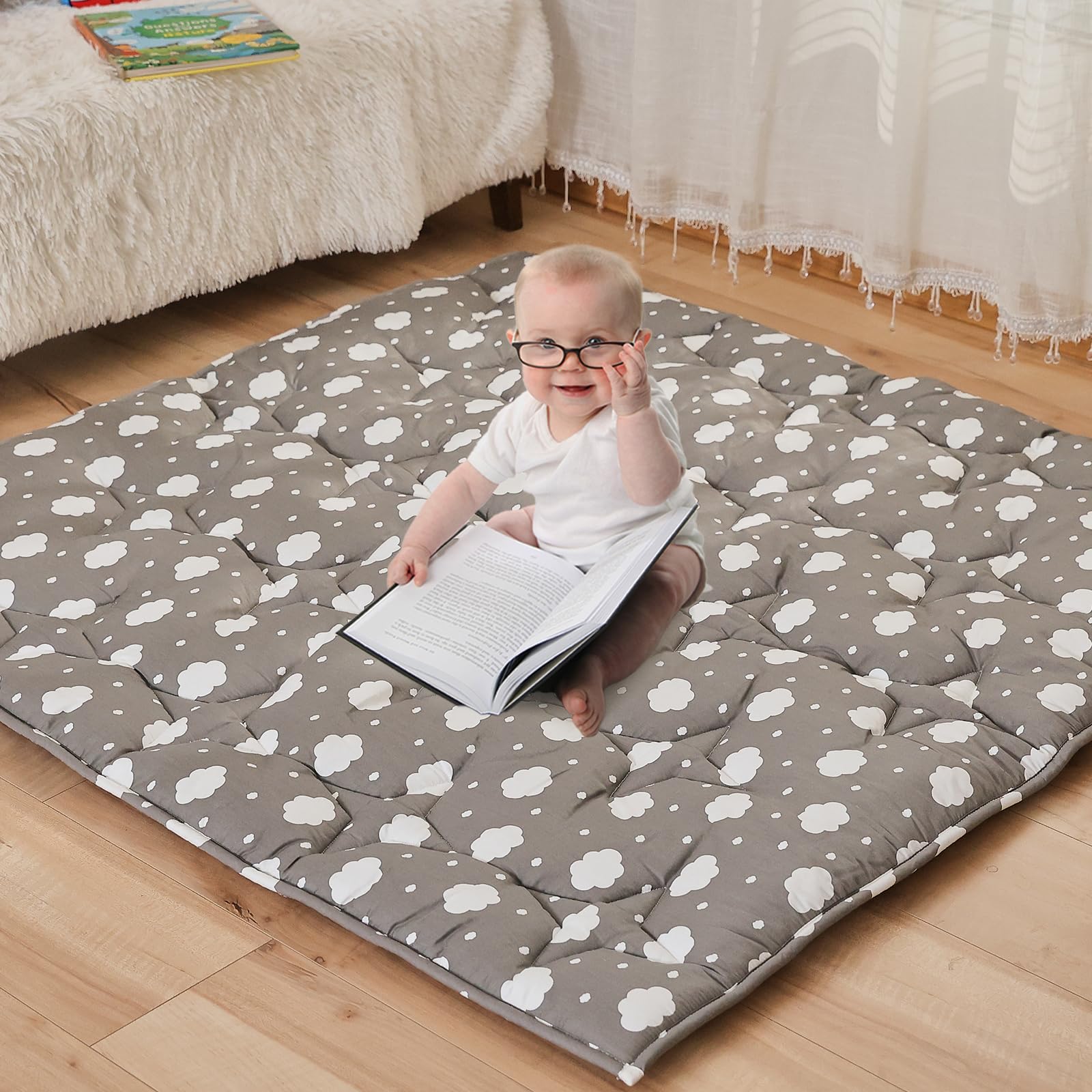 NapCure cloud-pattern play mat laid flat for safe baby playtime