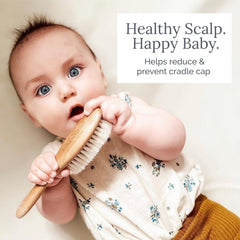 Natemia infant scalp-massage brush close-up shows soft bristles for soothing touch.