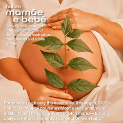 Natura Mamae e Bebe moisturizing shower oil applied during bath for hydration.
