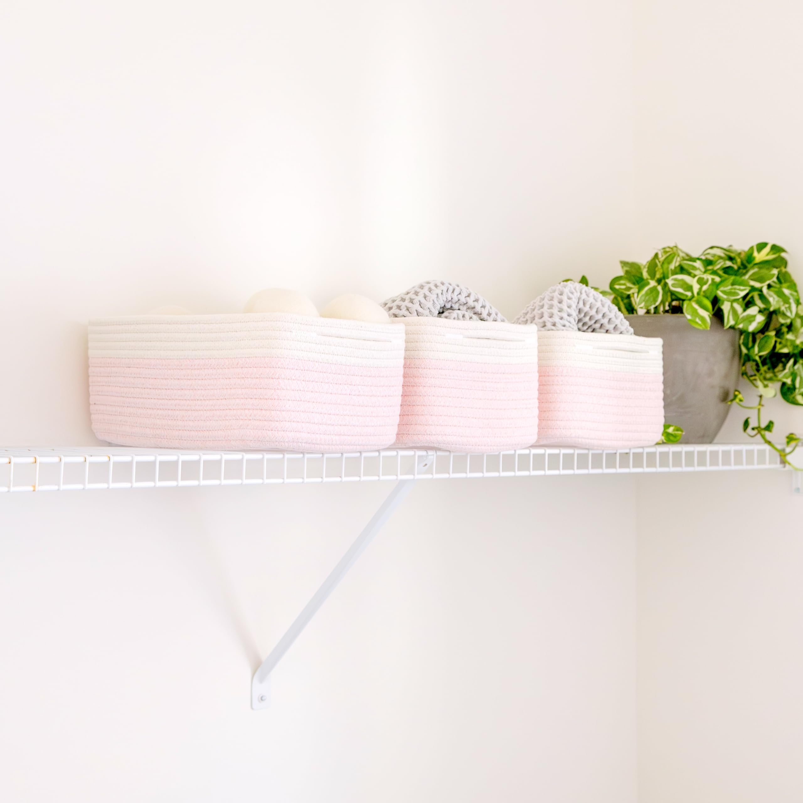 NaturalCozy rectangle basket decorative-organizer on a closet shelf.