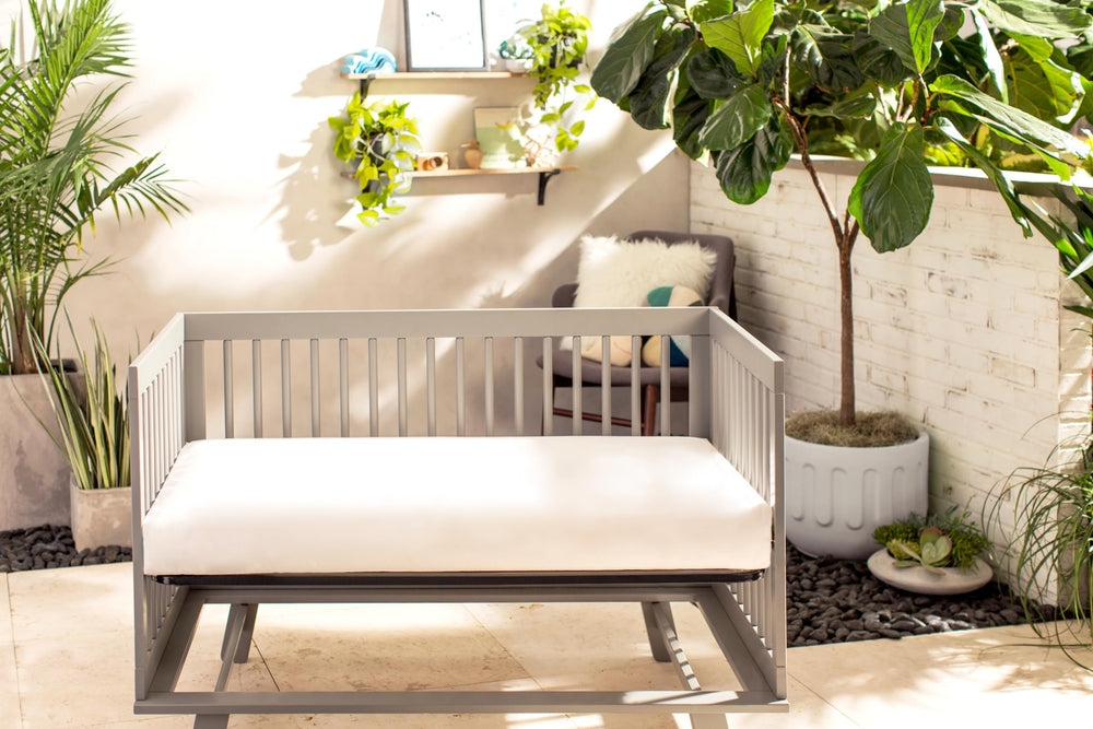 Naturepedic Organic Baby Crib Mattress waterproof coating close-up highlights easy-clean surface.