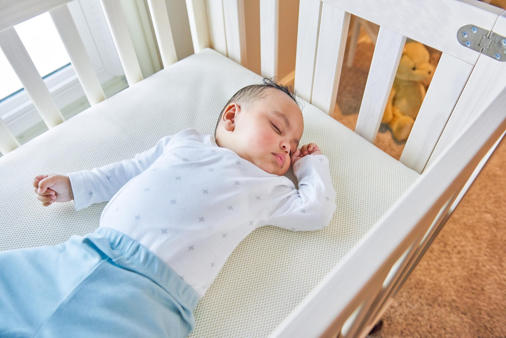 Naturepedic Organic Mini Crib Mattress lightweight core enables quick sheet changes