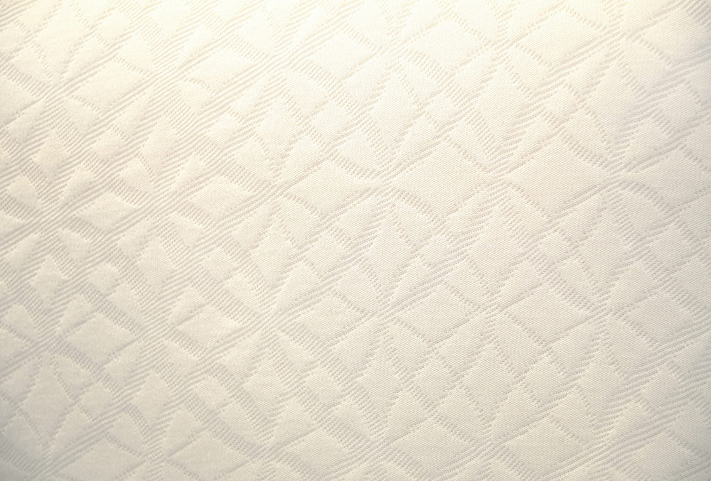 Naturepedic standard-size crib mattress pictured in a cozy nursery setup