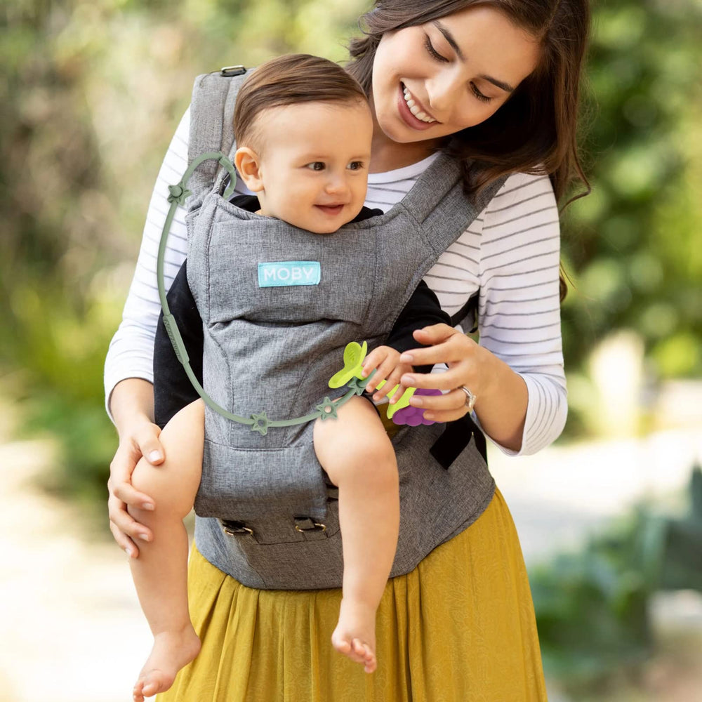 Nearbyme toy straps securing a toy and snack, demonstrating multifunctionality.