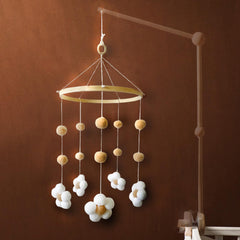 Nerdichic baby crib mobile with felt daisy flowers promotes gentle visual engagement.