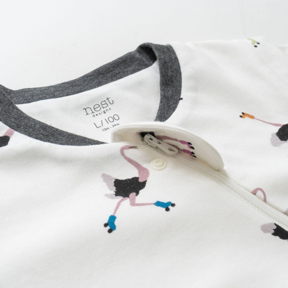Nest Designs sleep bag with removable sleeves in a cozy infant scene for seasonal versatility.