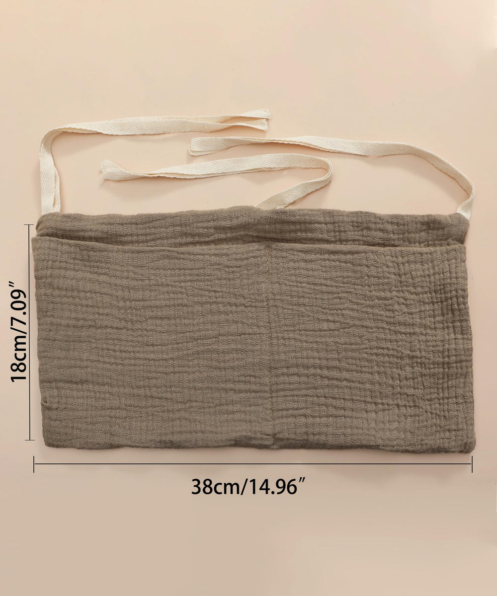 NewLuyer bedside organizer shows diapers, wipes, bottles in two handy pockets.