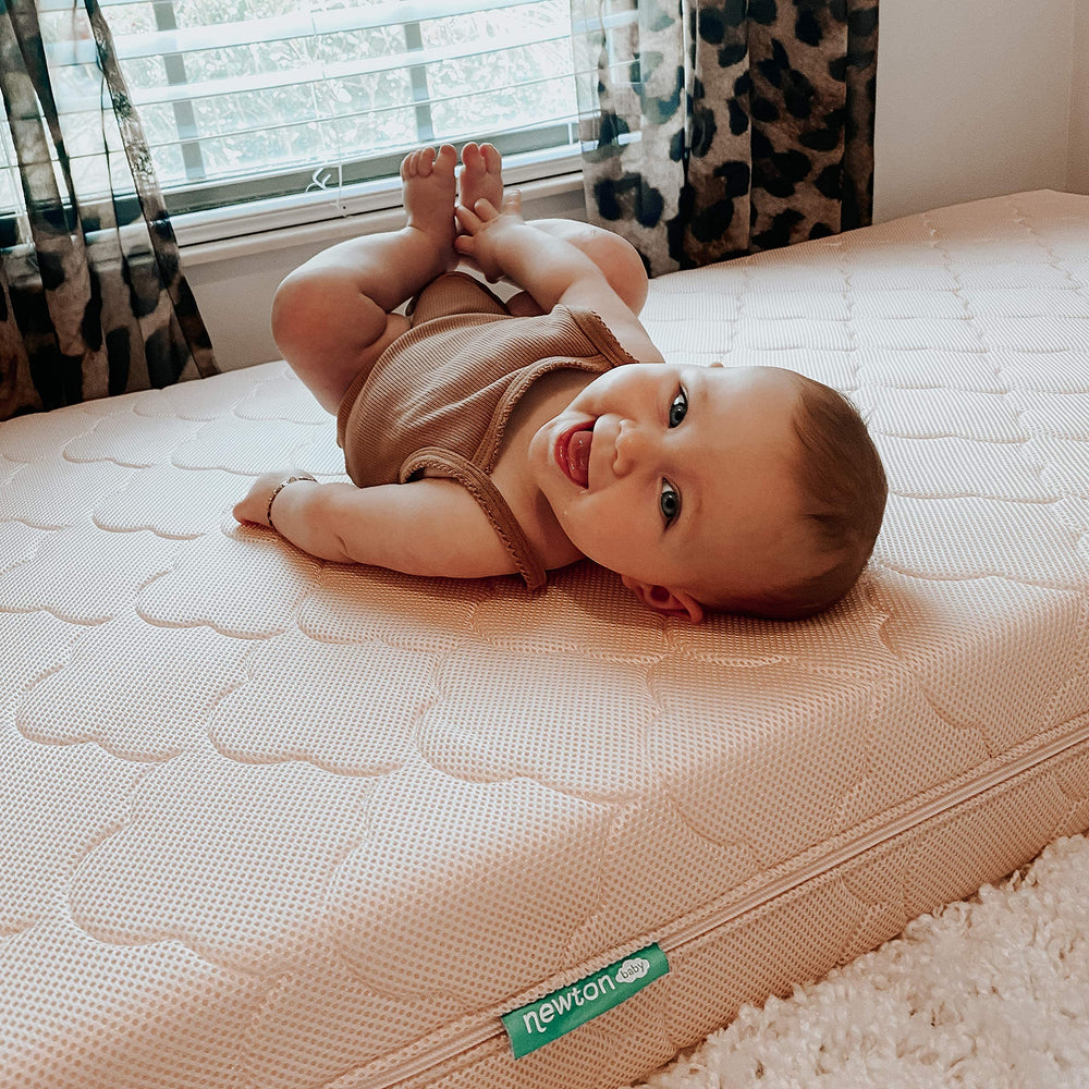 Newton Baby cloud white spare cover on crib highlights color and fit