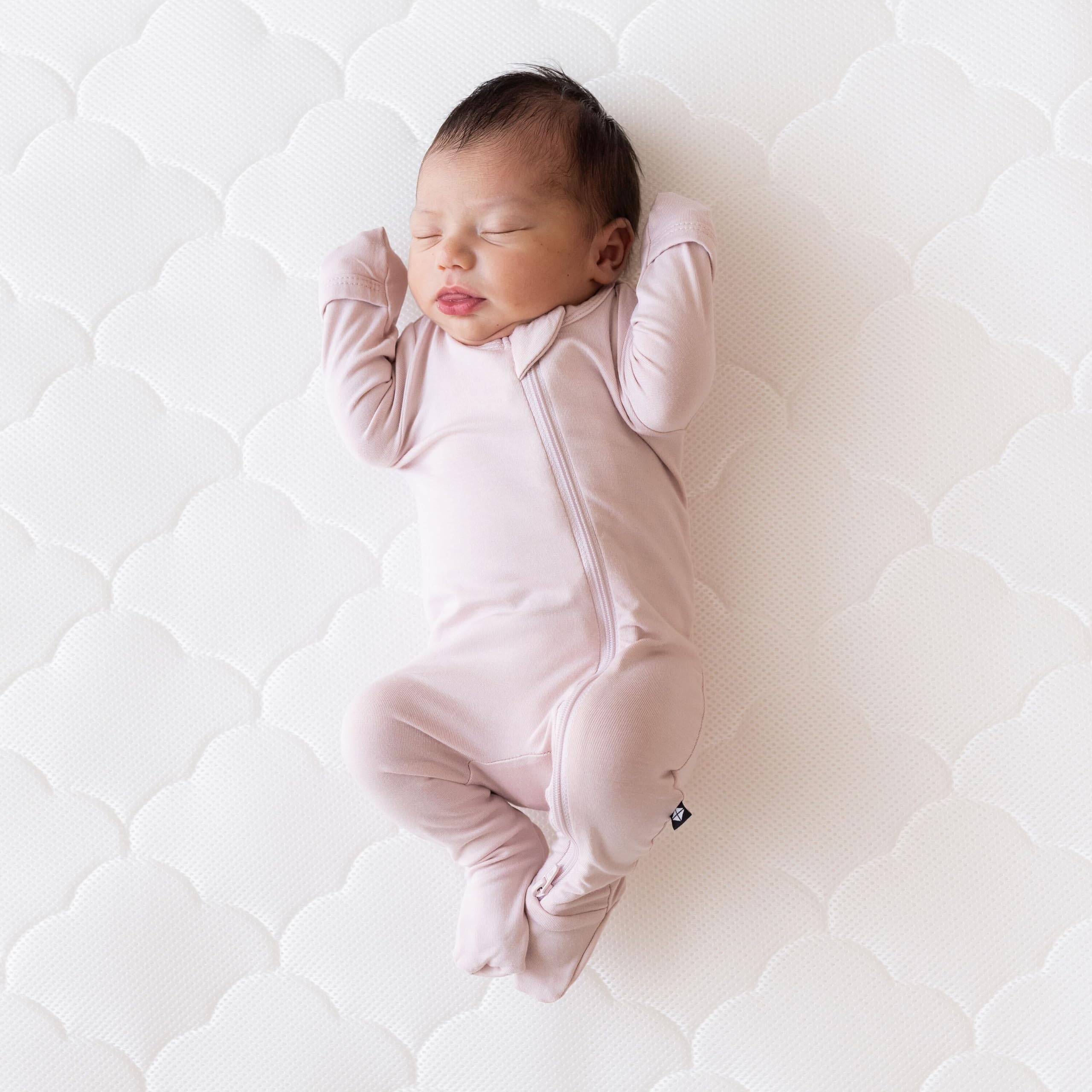 Newton Baby cover zipper detail emphasizes secure fit for nursery practicality