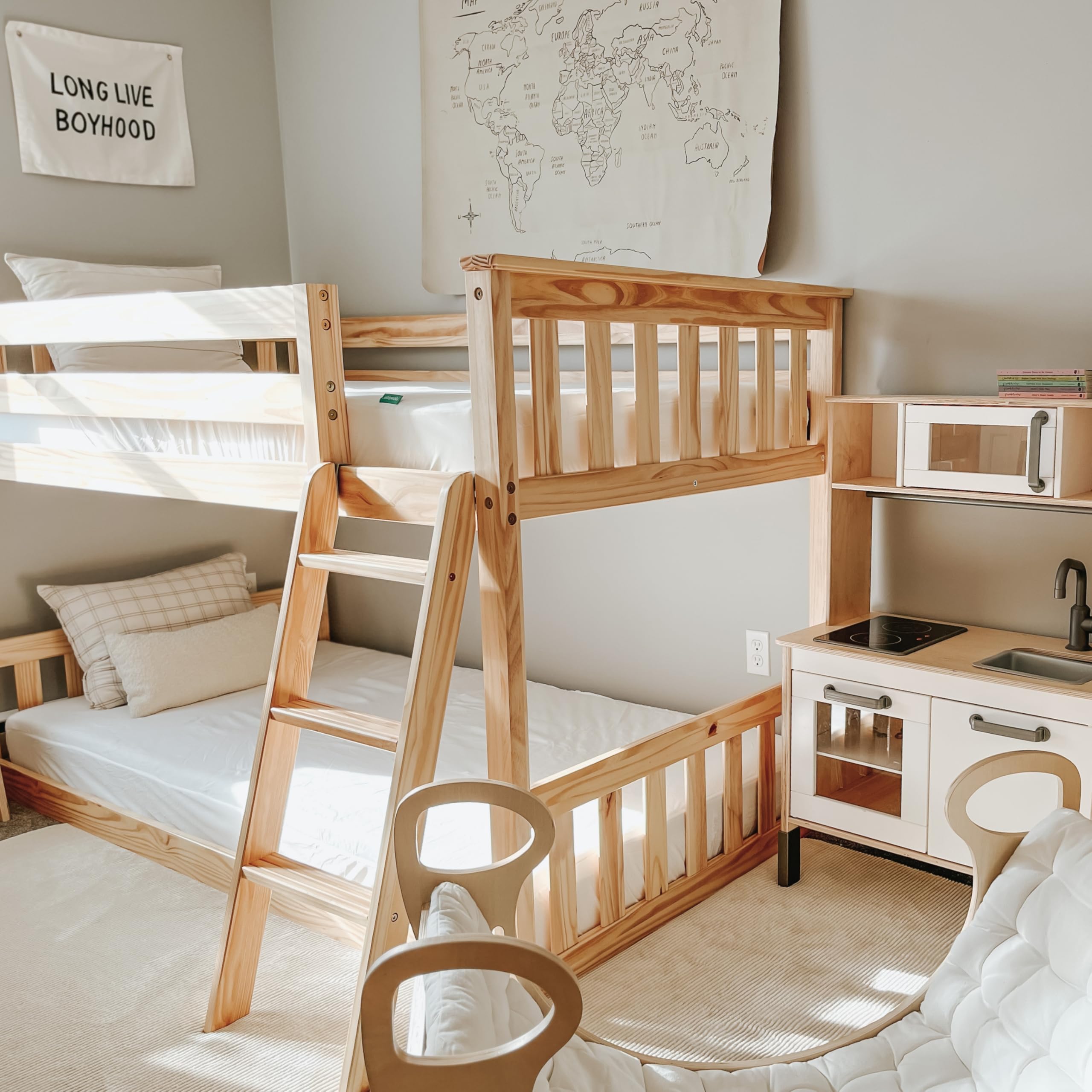 Newton Baby Cream Organic Twin Mattress Pad displayed in a cozy nursery room