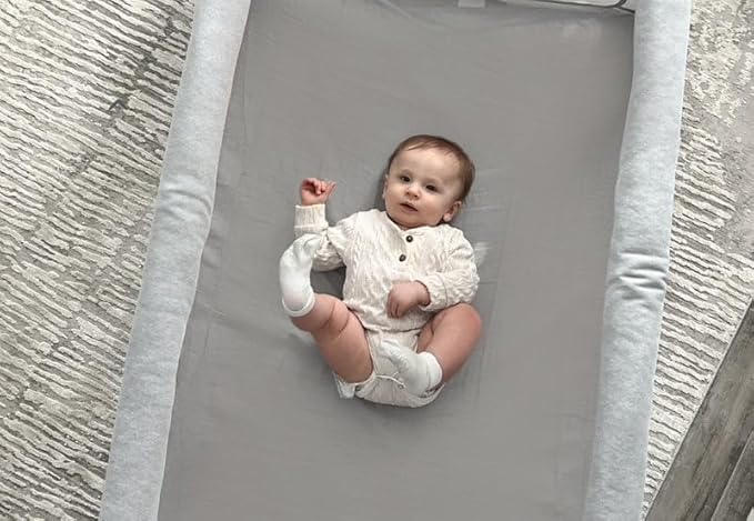 Newton Baby muslin sheet highlights hypoallergenic softness for baby skin.