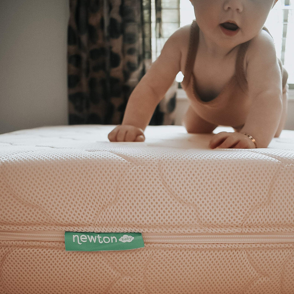 Nursery scene showing Newton Waterproof cover ready for sleep routine