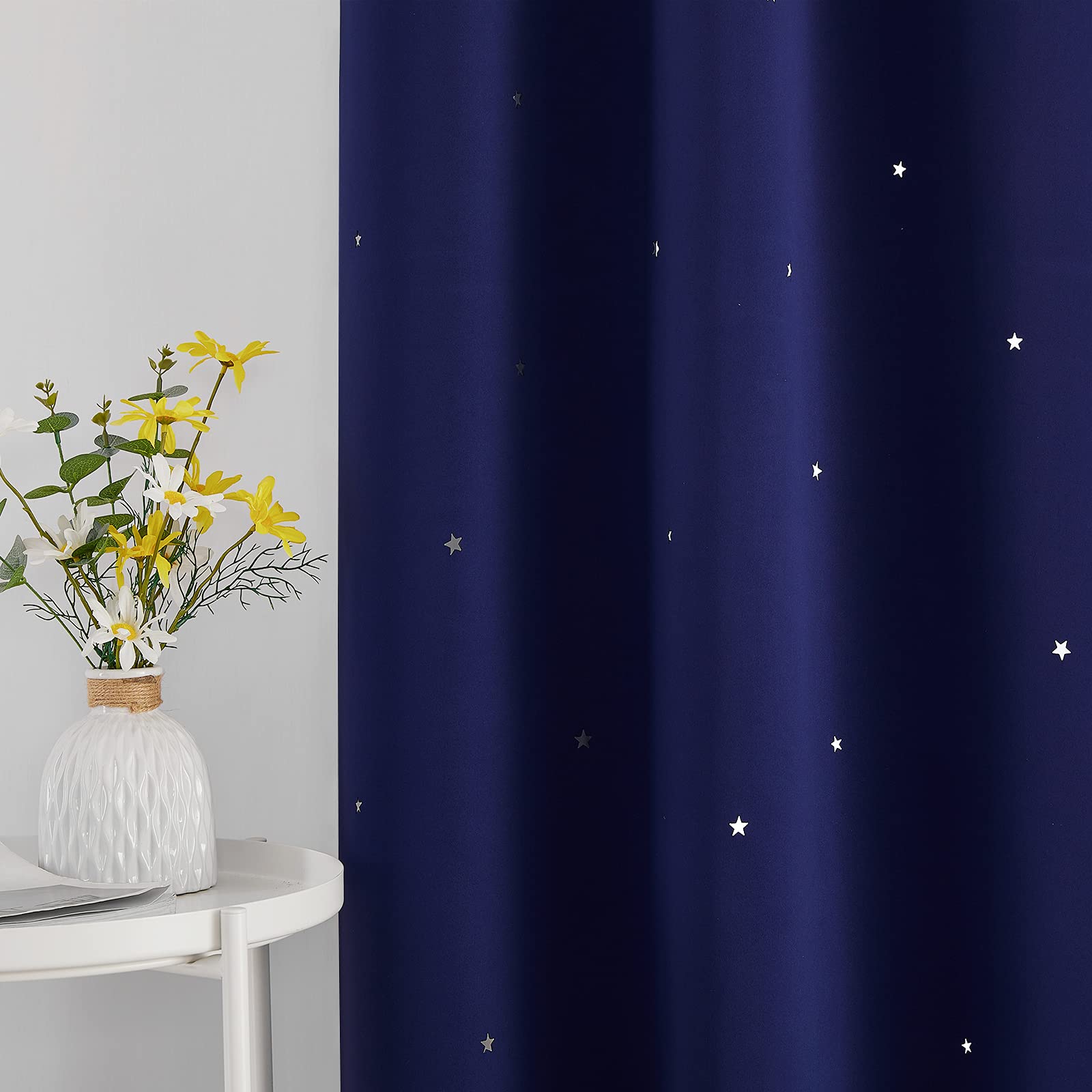 NICETOWN navy-blue blackout curtain with grommets showcasing easy installation and smooth sliding.