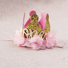 Nishine gold glitter crown headband with pink chiffon flower at a party setup