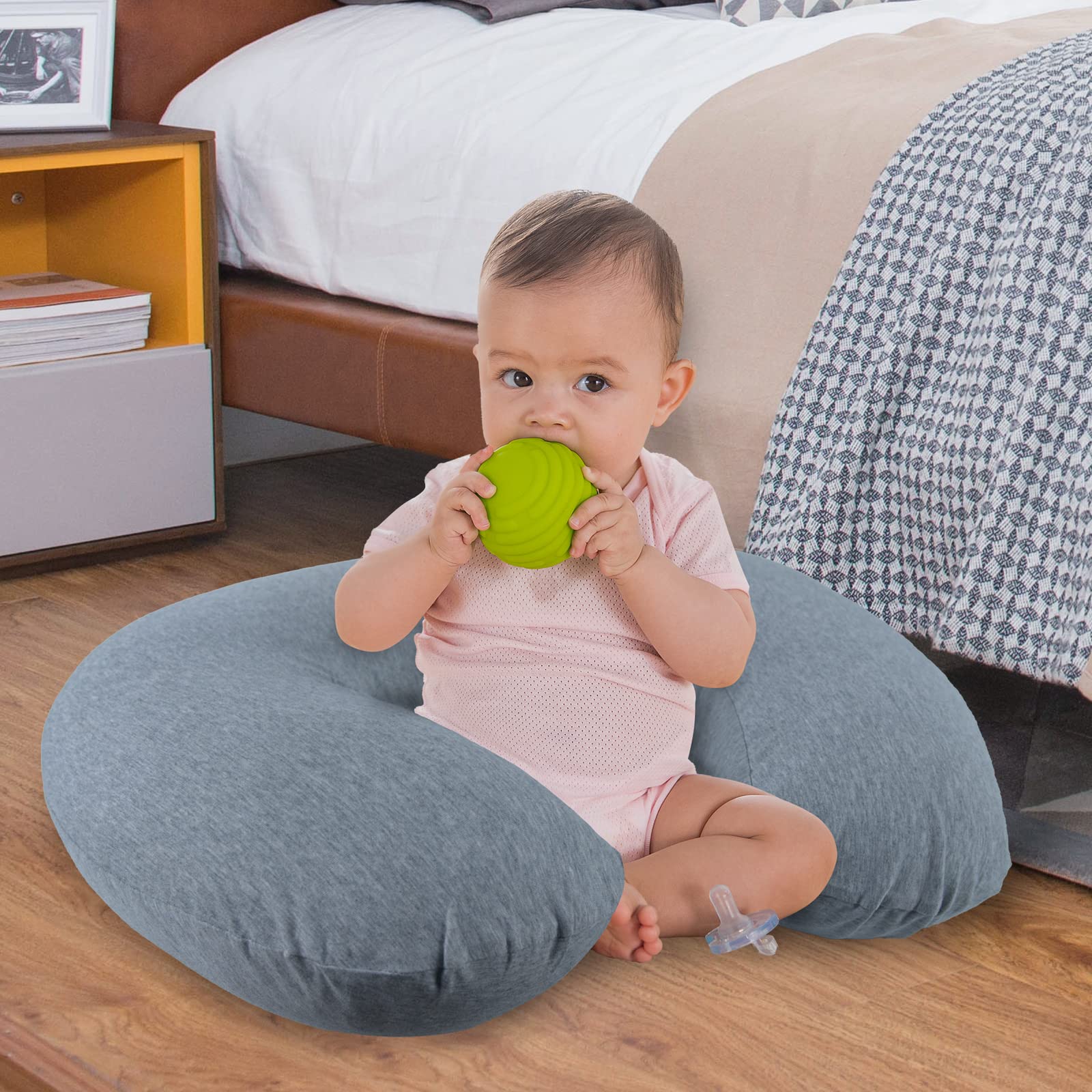 NiSleep pillow on bed demonstrates versatile support for tummy time and lounging.