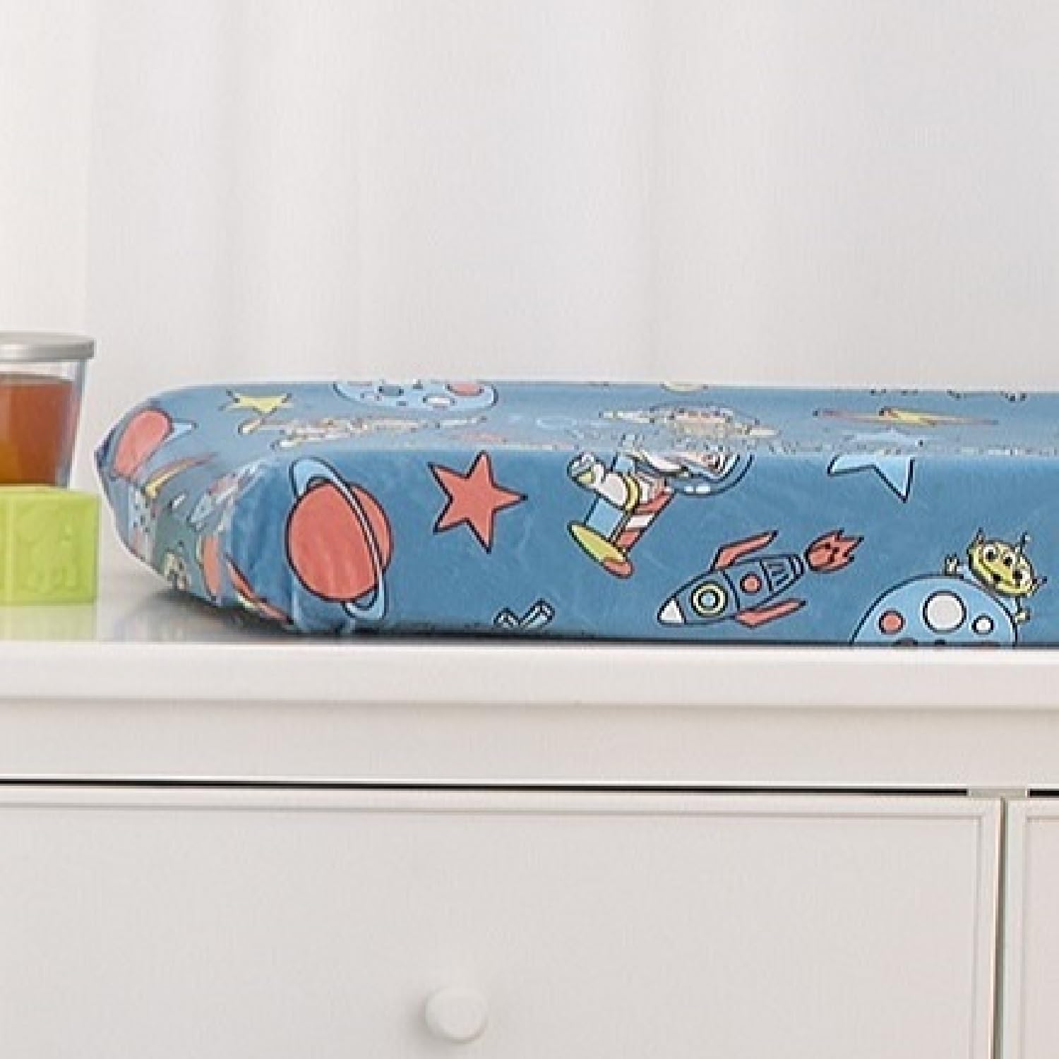 NoJo Buzz Lightyear changing pad cover on pad edge demonstrates secure tuck