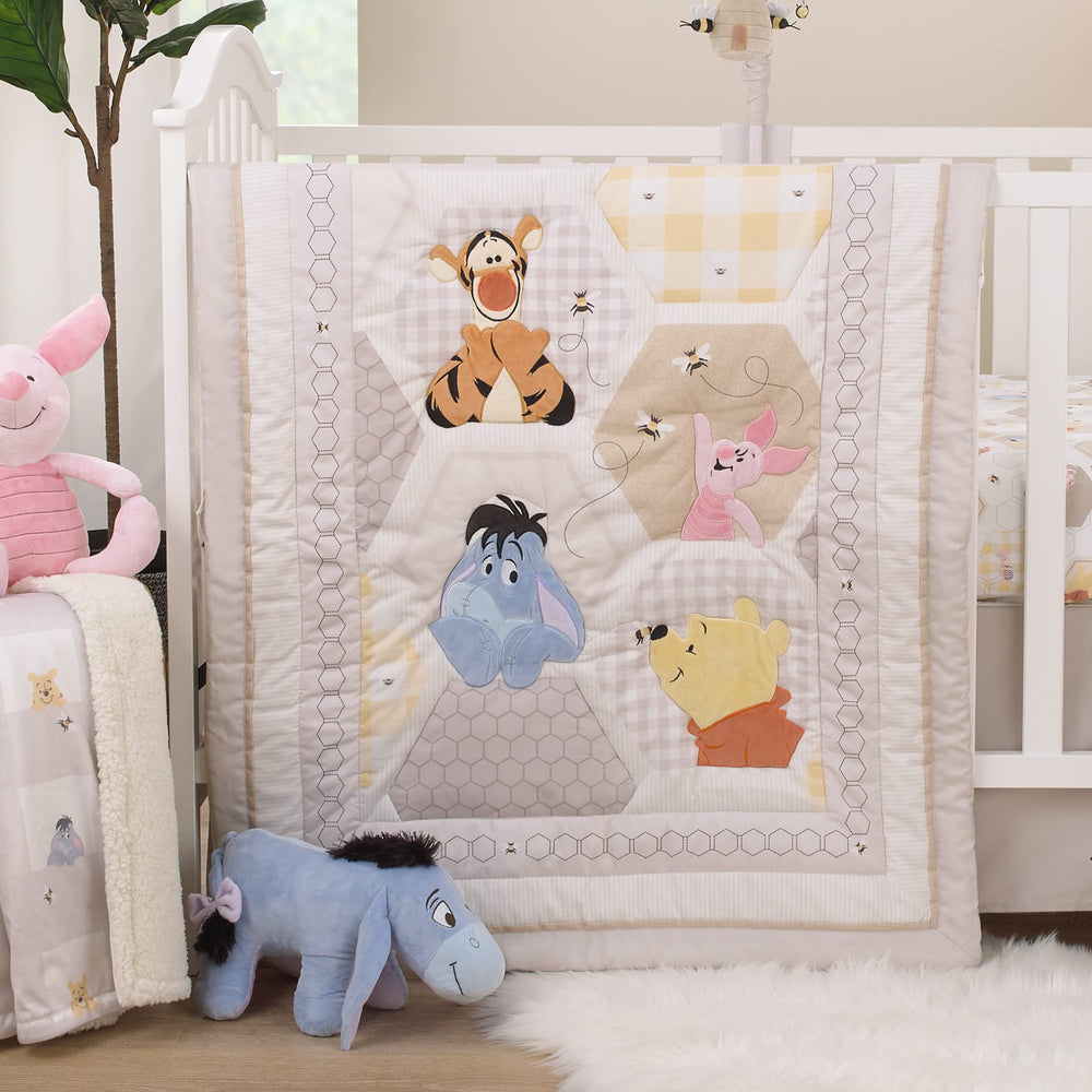 Coordinating Disney Winnie the Pooh collection creates a cohesive nursery theme.