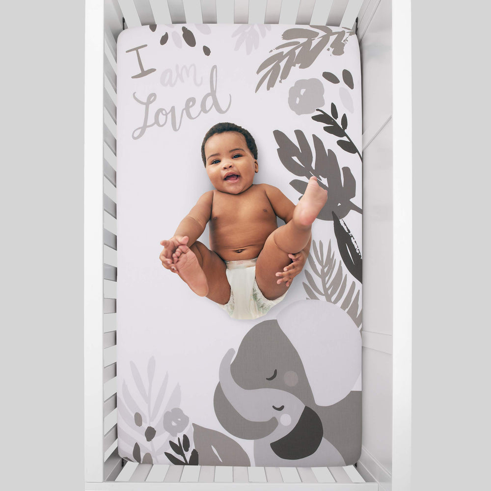 NoJo Elephant Hugs crib sheet design with elephants and I am loved message for cozy photo ops.