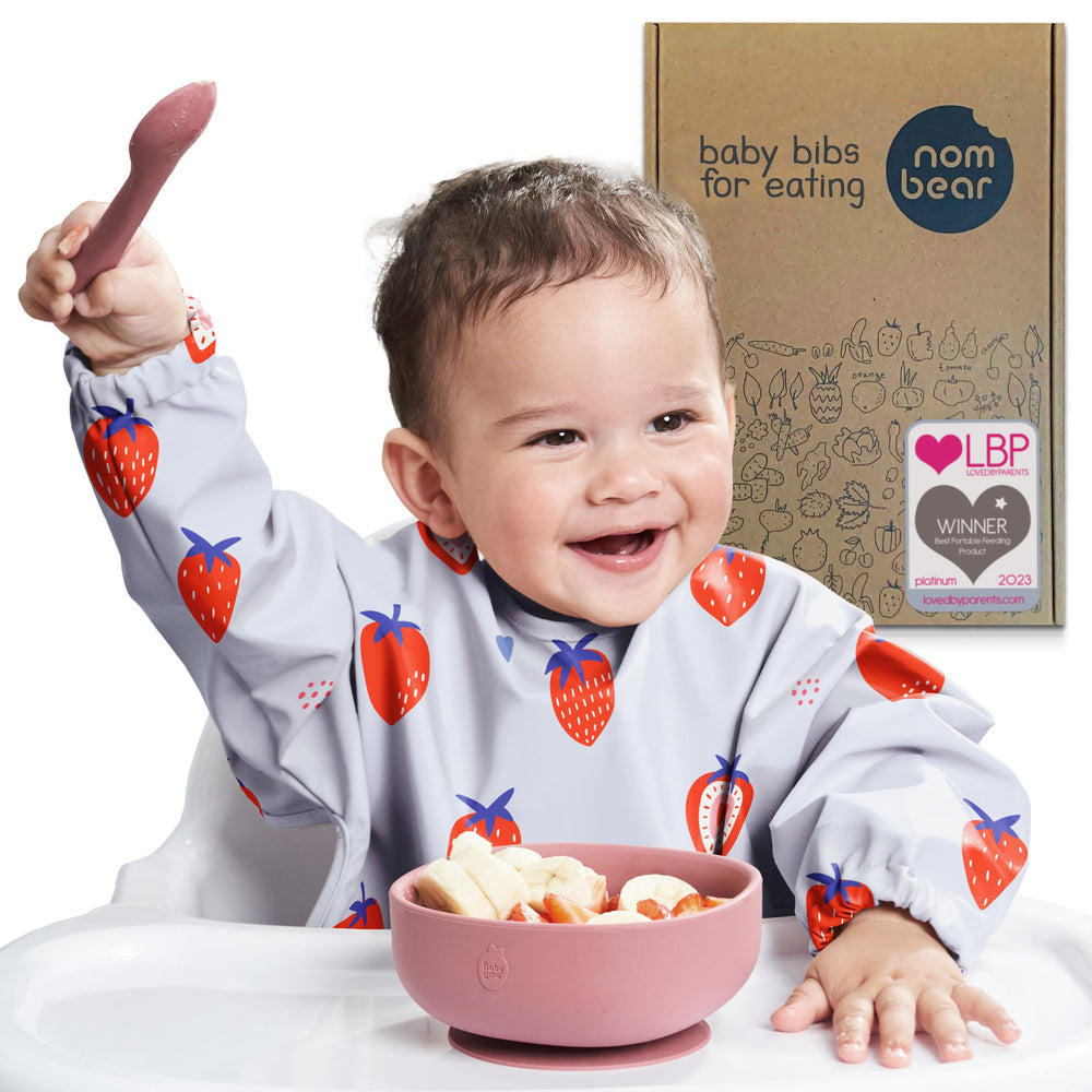 Nombear smock bib model wearing during mealtime to keep outfits clean.