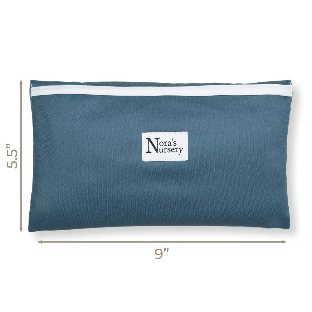 Nora's Nursery Sea changing pad in use on a table during travel.