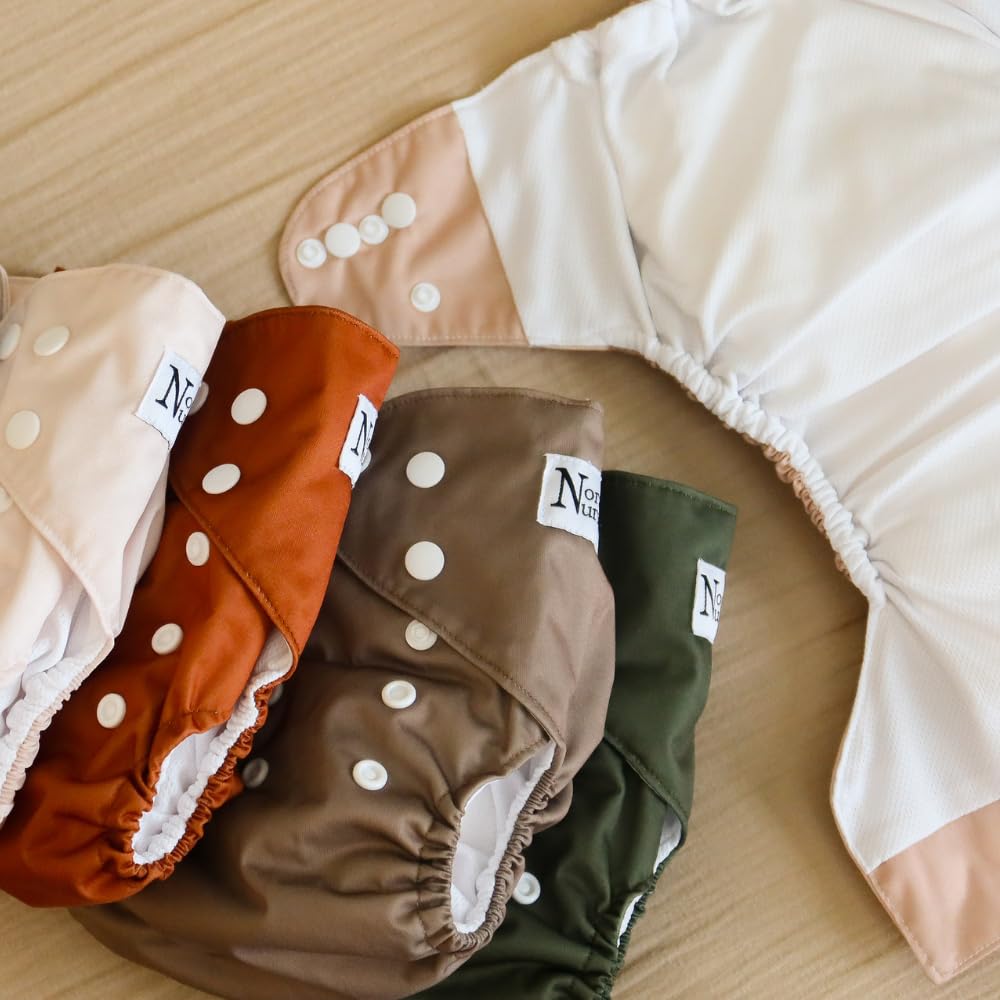 Nora's Nursery AWJ designs variety image showcasing prints and earth-toned palettes for baby style.