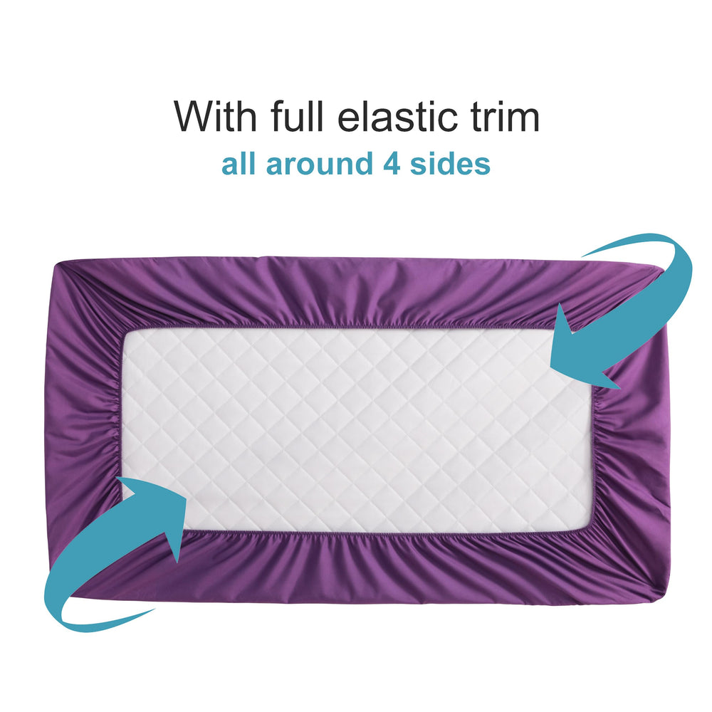NTBAY mini-crib protector with elastic trim demonstrating a secure four-side fit.