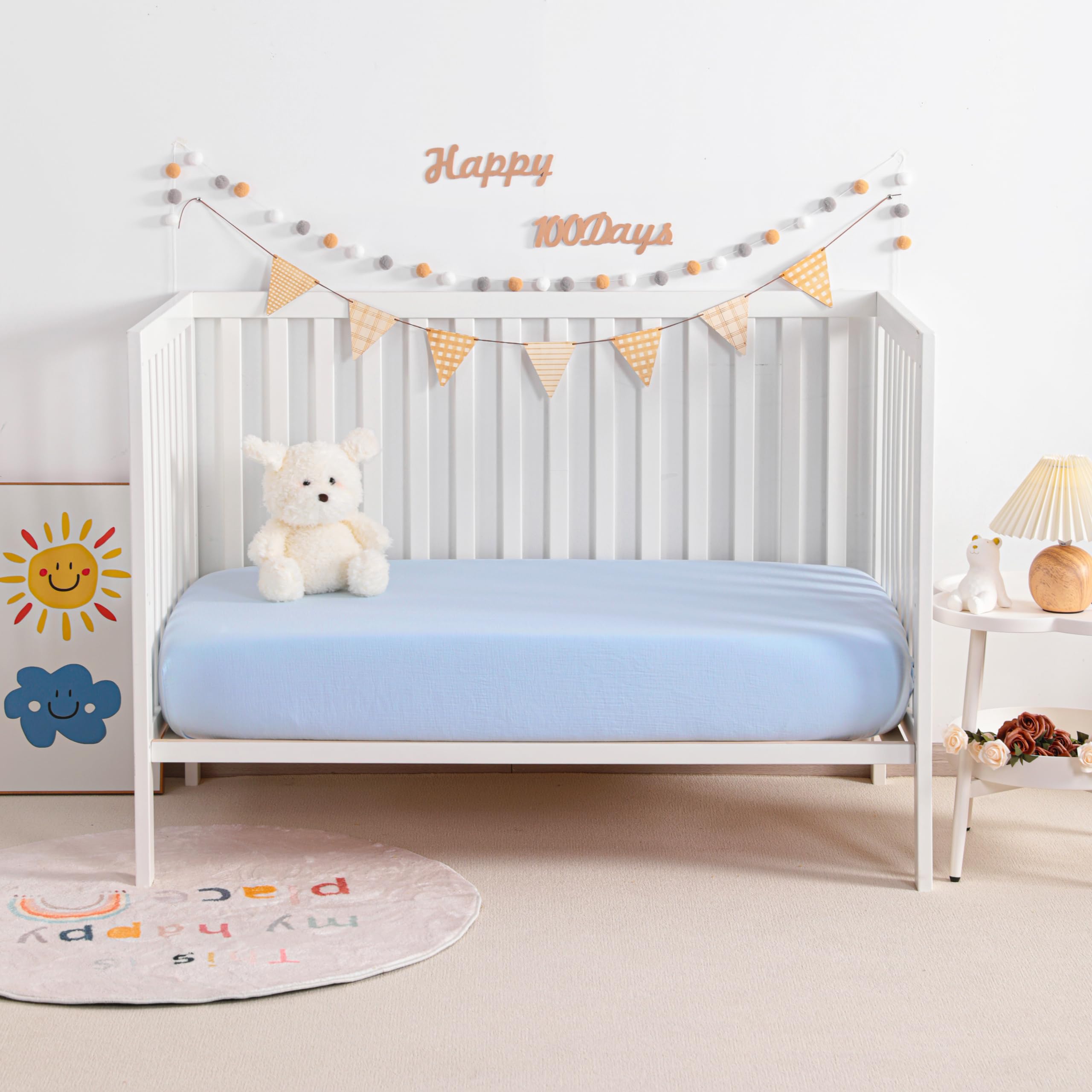 NTBAY mini-crib-sheets-aqua-folded to highlight snug fit and easy handling.