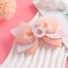 Nuolich glitter birthday bow peach clip-detail demonstrates secure hair hold.