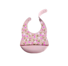 NURTUREBLOOM silicone feeding bib with blush pink roses for mess containment during feeding.