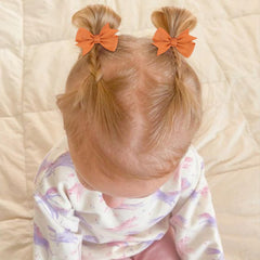 OAOLEER tiny bows alligator clip closeup showing secure, gentle grip for delicate hair