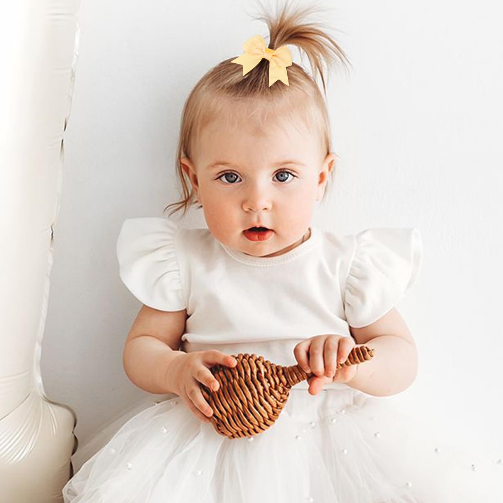 OAOLEER mini 2-inch bows on elastic ties add soft color to tiny hairstyles.