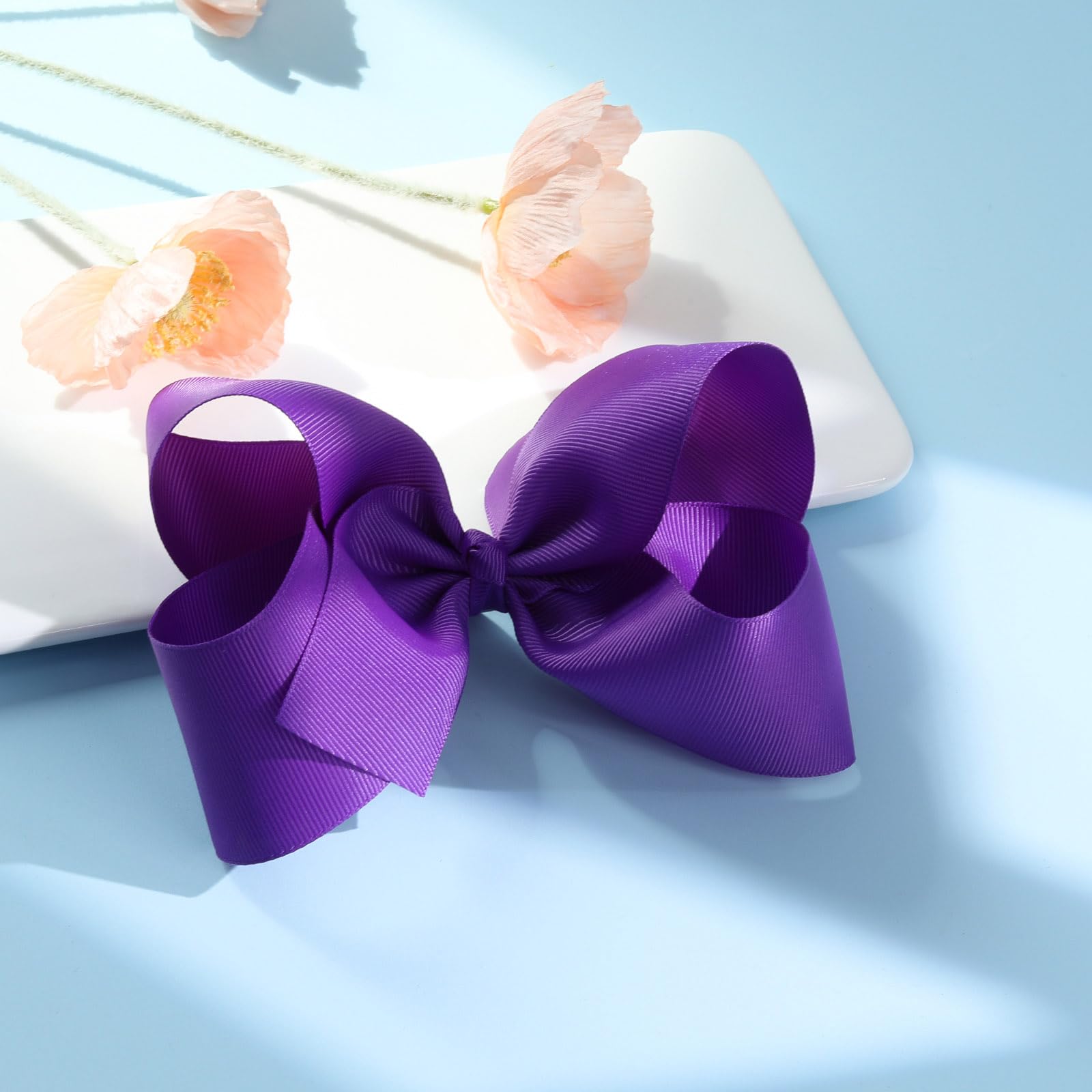 Girl wearing a purple Oaooleer bow to complete her outfit.