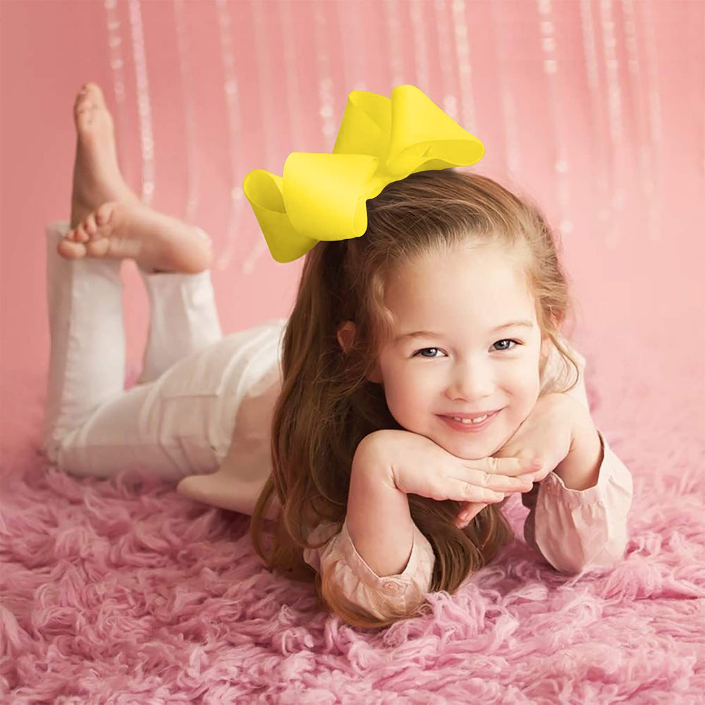 Oaooleer 6-inch yellow grosgrain bow with alligator clip for sweet school-day looks.