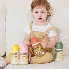 Oberni weighted straw toddler cup with handles enabling easy sipping from any position