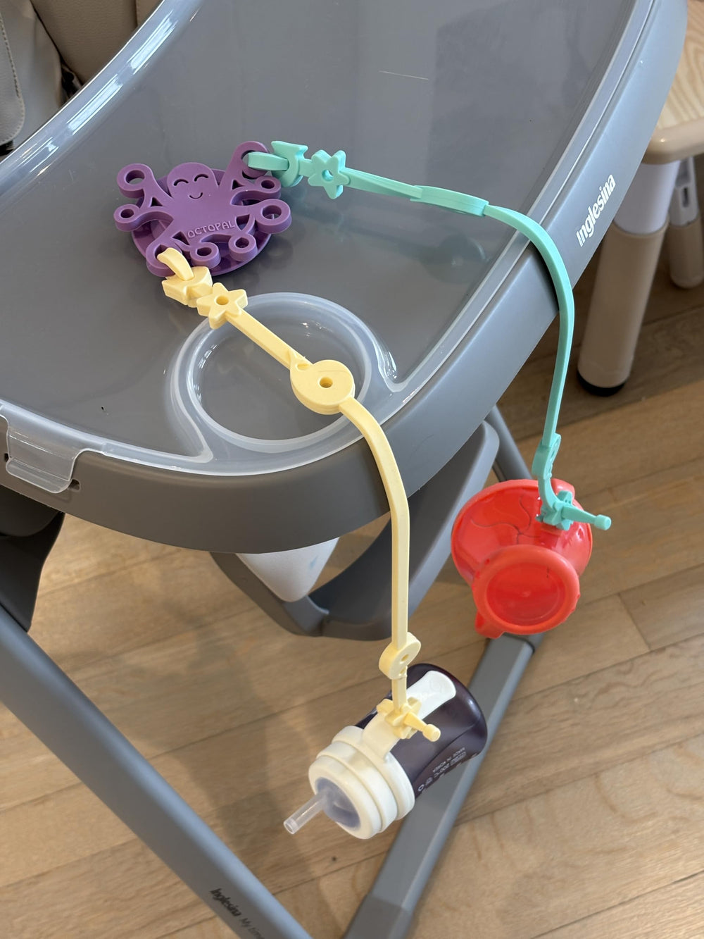 Octopal Baby Tether Straps looped around a high chair for versatility.