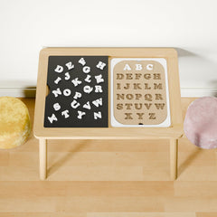 Ogears alphabet board insert on Flisat Trofast enhances tactile exploration and creative storytelling.