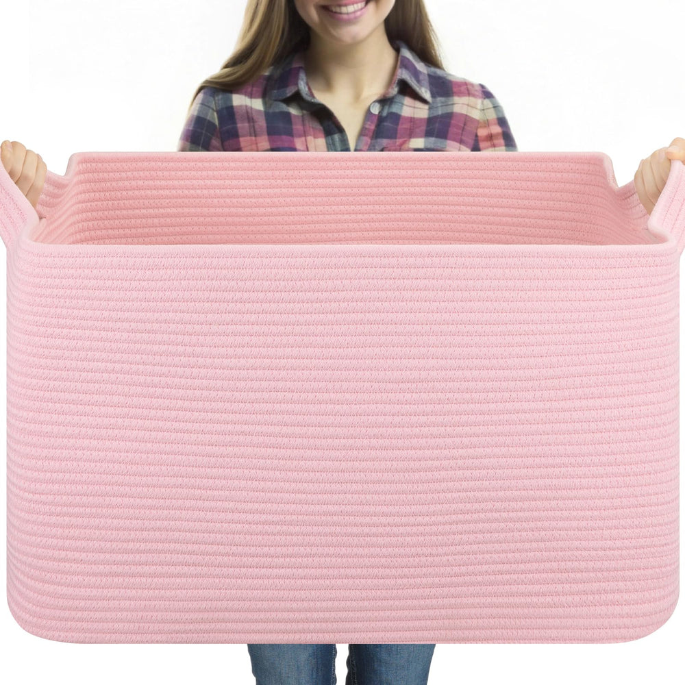 OIASKET 95L blanket basket on living room floor storing blankets and pillows for easy access.