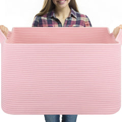 OIASKET 95L blanket basket on living room floor storing blankets and pillows for easy access.