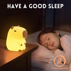 Okayera capybara nursery lamp adds gentle illumination to a cozy nursery shelf.