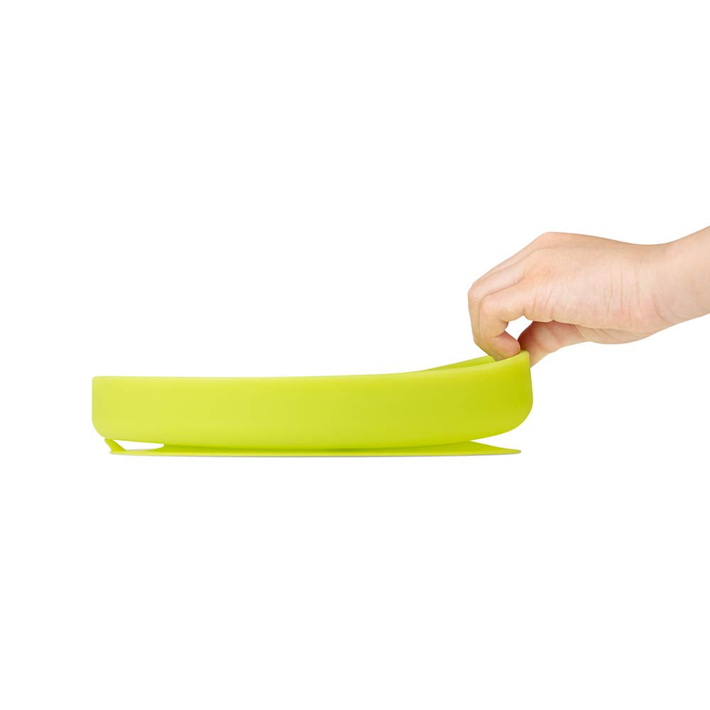 Olababy plate being cleaned under running water highlighting dishwasher-safe design.