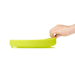 Olababy plate being cleaned under running water highlighting dishwasher-safe design.